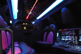 Interior view of vehicle showing mirror lights, bar area and privacy screen